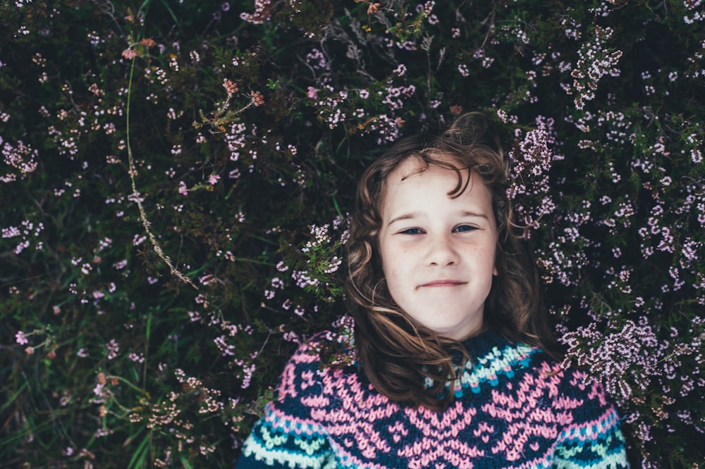 woman laying on green grassfield