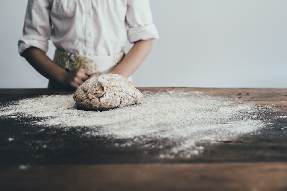 a person standing in front of a pile of flour