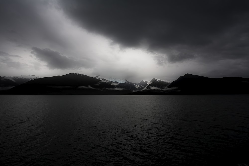 body of water during cloudy daytime