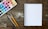 A close-up of an open book with artistic illustrations and a paintbrush beside it.