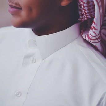 A close-up of a sleek black thobe with subtle embroidery, highlighting the fabric texture.