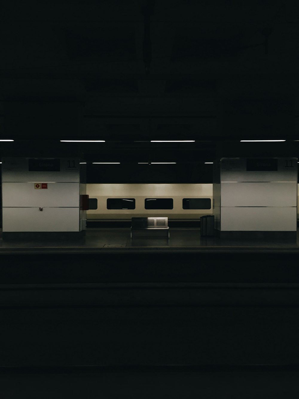 gray metal bench at the train station