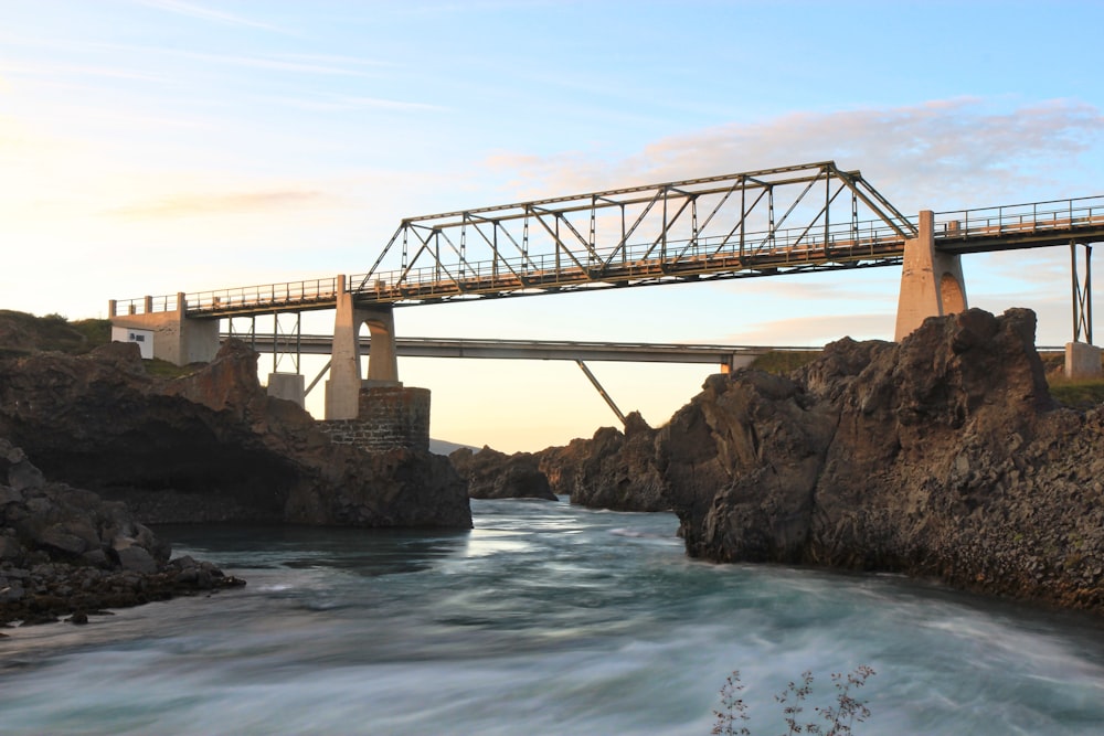 brown bridge over blue sea under blue sky during daytime