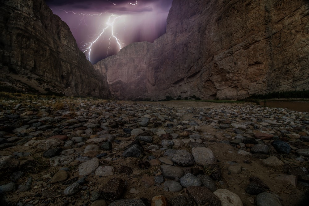 lightning hitting brown rock mountain