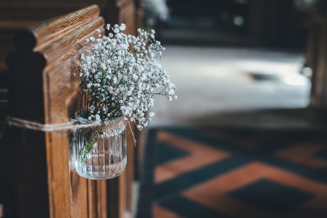 white petaled flower on glass vase