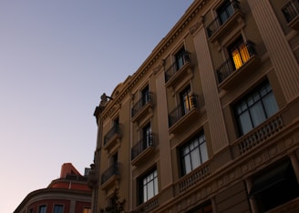 Elegant luxury residential building with subtle 3D shadows at dusk.