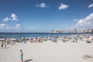 A vibrant Miami beach scene at sunset with colorful umbrellas and people enjoying the warm weather.