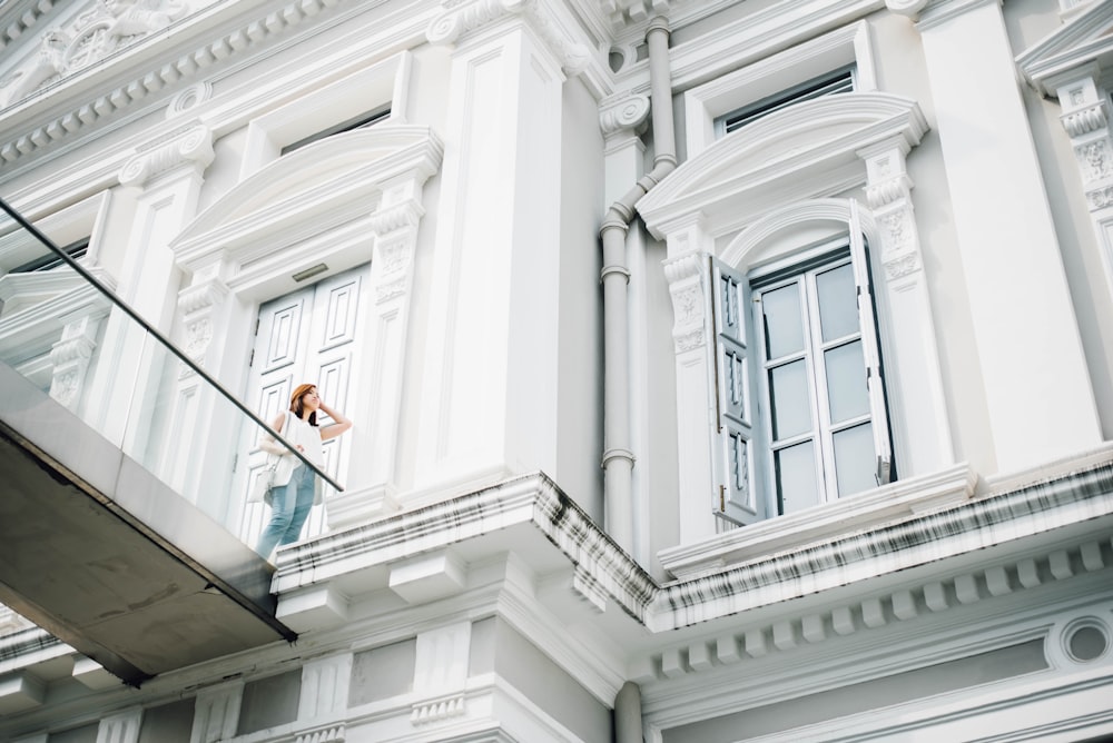 woman standing on white concrete building terrace