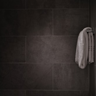 white bath towel hanged on bar