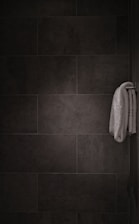white bath towel hanged on bar