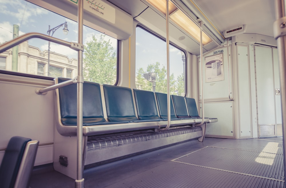 a empty train car with blue seats and windows