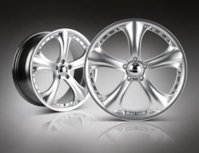An array of stylish alloy wheels displayed in a well-lit showroom.