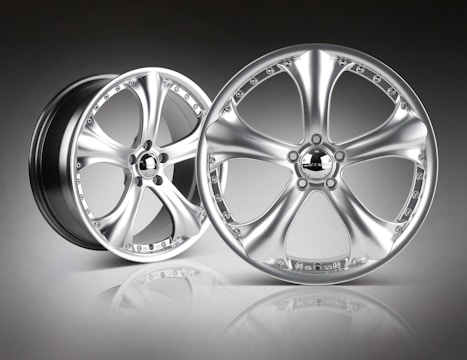 A stylish aluminum wheel displayed on a showroom floor.