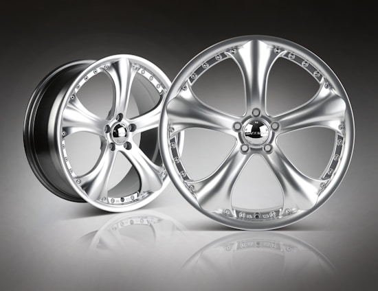 A sleek aluminum wheel displayed in a modern showroom.