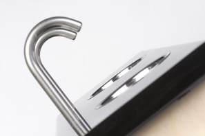 Close-up of a polished hansu handcuff showing its sturdy steel construction and locking mechanism