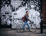 man walking in street while wearing red backpack