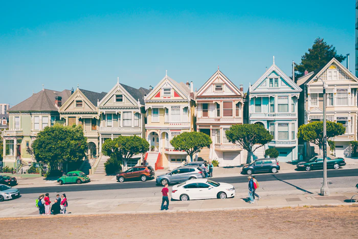 A row of painted Victorian houses on a city street