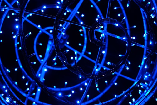 A network of bright blue LED lights arranged in circular patterns against a dark background, creating a glowing, intricate design.