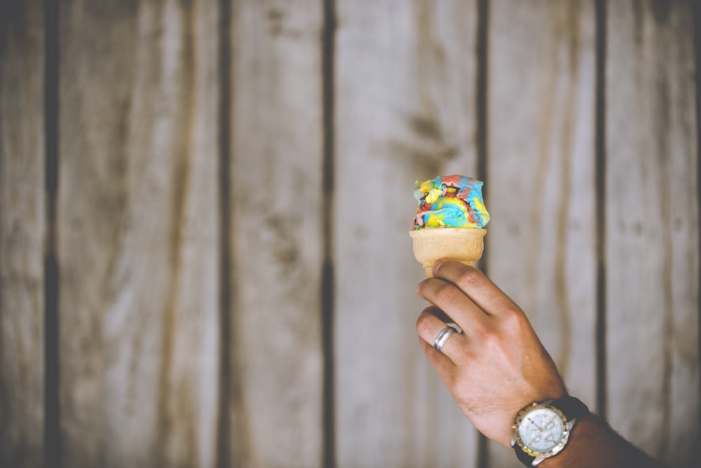 person holding multicolored ice cream