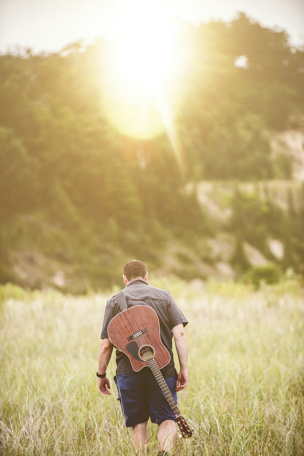 man walking on green grass field during daytime