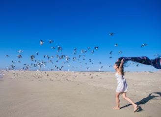A joyful woman running on a beach.