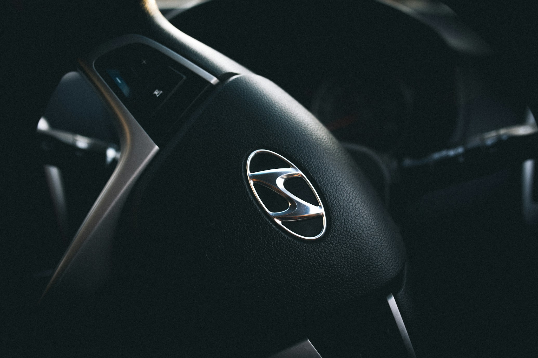 A Hyundai Steering Wheel in a mid turn going right