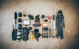 flat lay photo of camera gear on floor