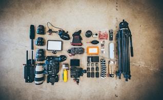flat lay photo of camera gear on floor