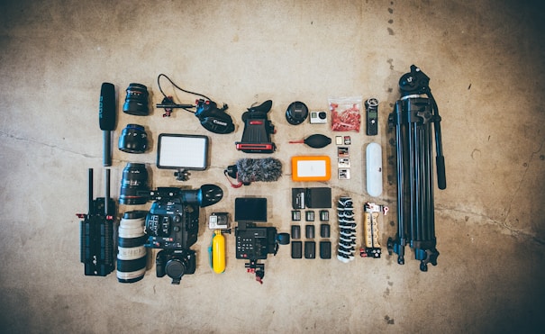 flat lay photo of camera gear on floor