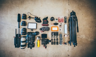 flat lay photo of camera gear on floor