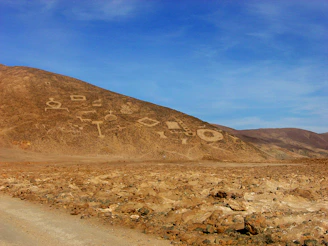 Ancient geoglyphs etched into the desert landscape under a clear blue sky