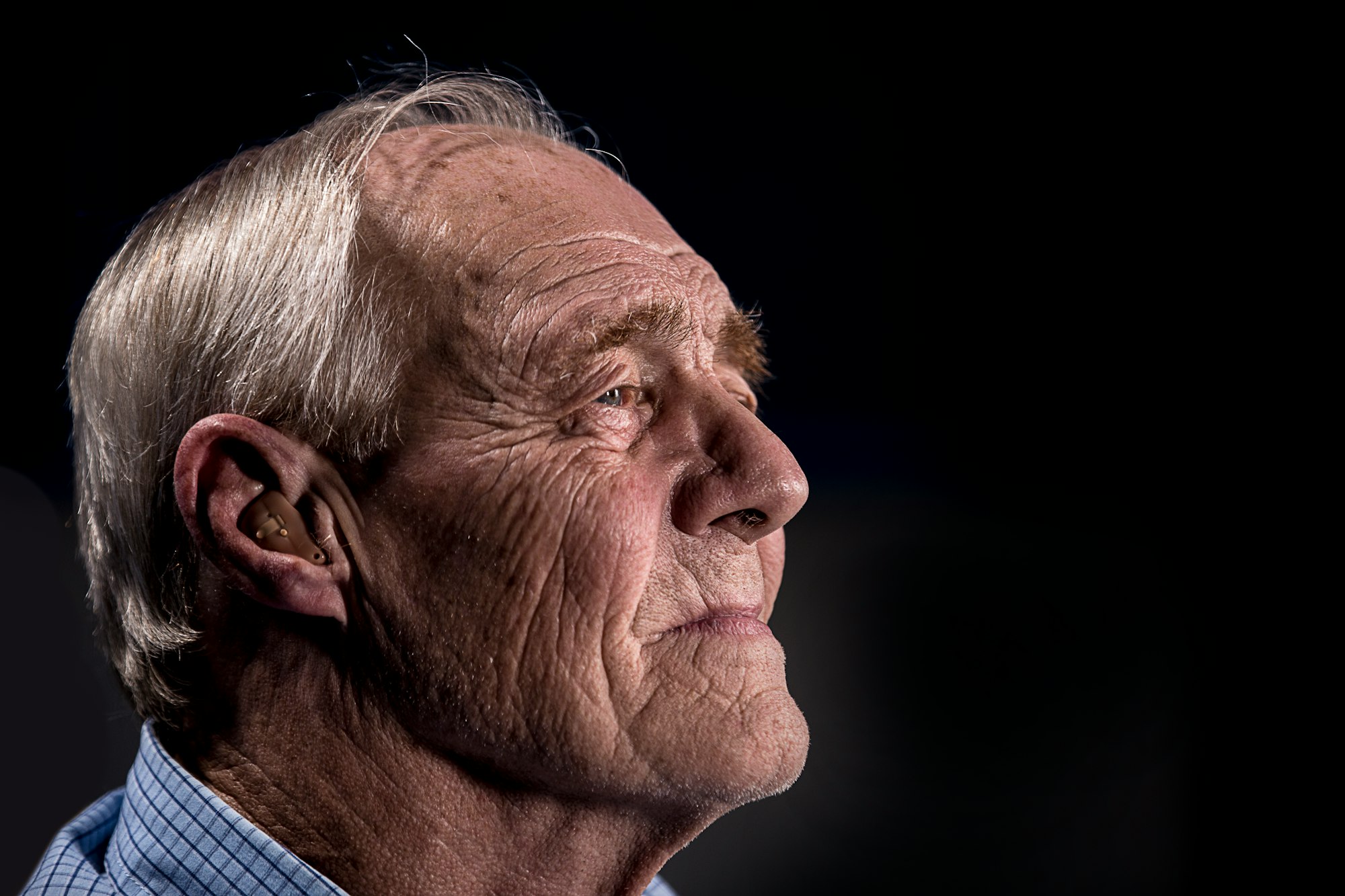 Old man with hearing aid.