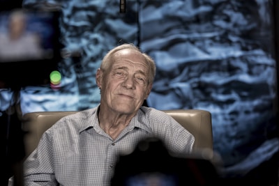 Man seated on a chair, captured during a documentary production