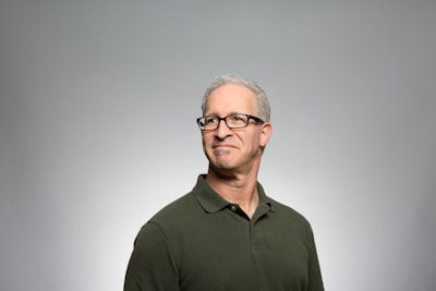 man wearing green polo shirt portrait google meet background