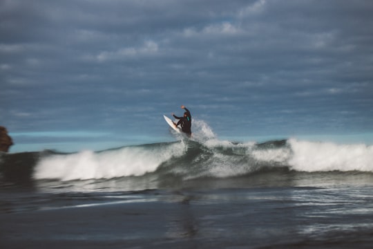 person surfing during dytime in Piha New Zealand