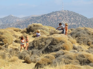 Children participating in an educational desert tour, observing wildlife and plants.
