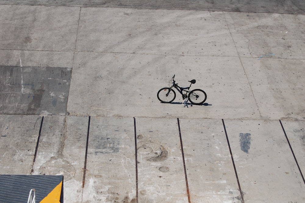 black bicycle parked on road