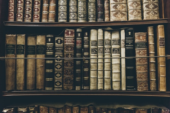 Elegant dark-themed photograph of a sophisticated law office with gold accents and leather-bound legal books.
