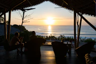 Guests enjoying a sunset on the private terrace with ocean breeze and comfortable seating.