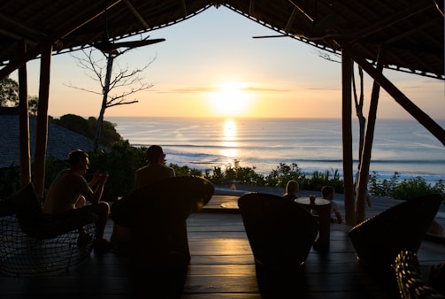 Guests enjoying a sunset view from the hostel terrace surrounded by natural elements.