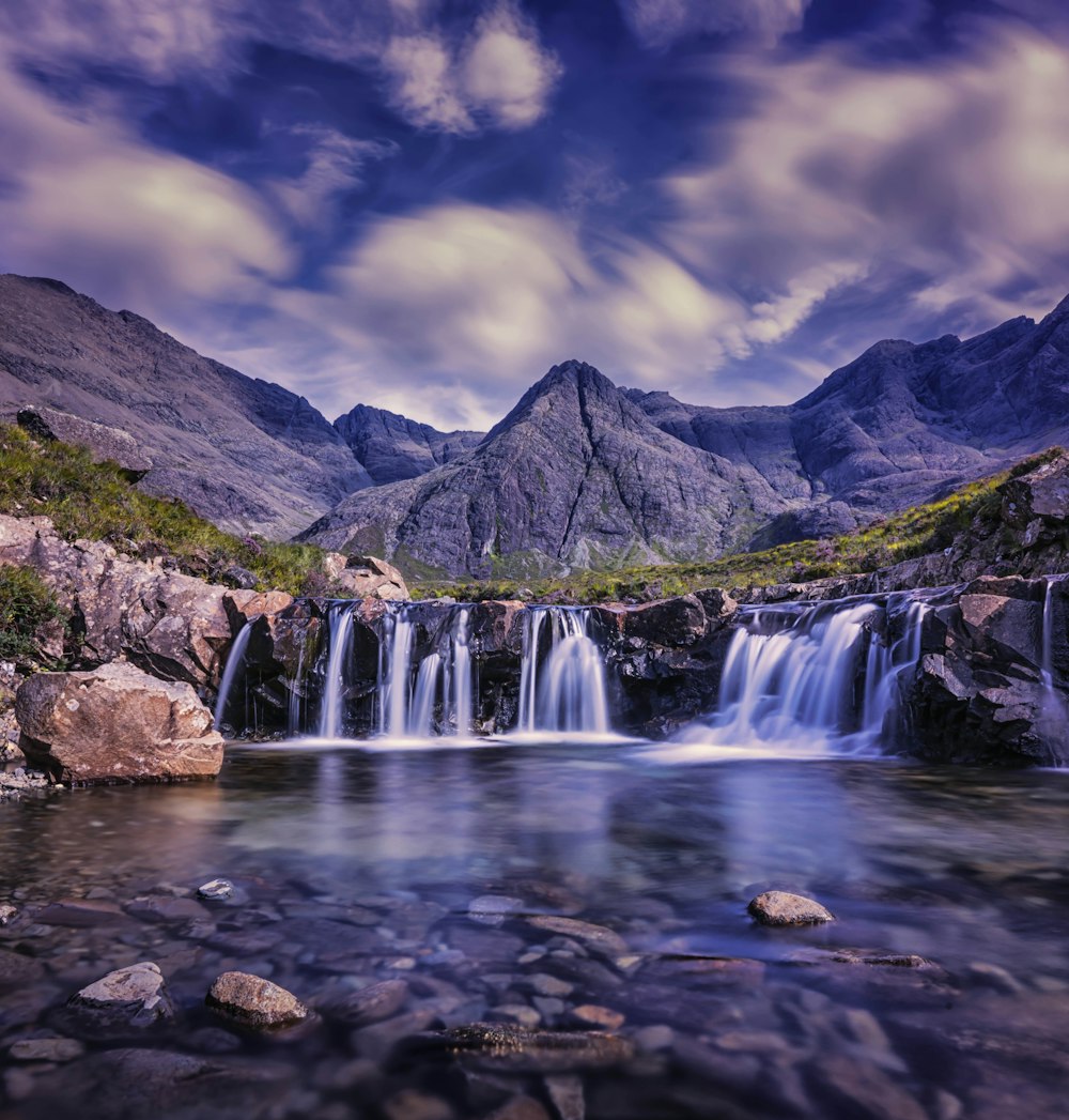 waterfalls under cloudy sky