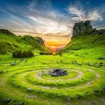 green grass field during sunset