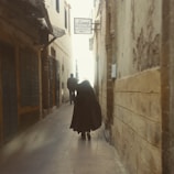 Character glance exchanged in shadowed alley, hinting at deep connections.