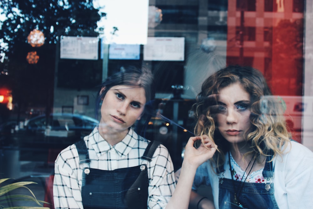 woman standing beside woman in blue dungaree