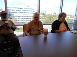 A candid moment of lawyers discussing case details over coffee in a bright, comfortable lounge.