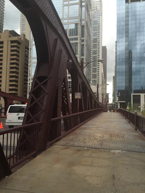 A Vertolink truck crossing a modern bridge with city skyline in the background