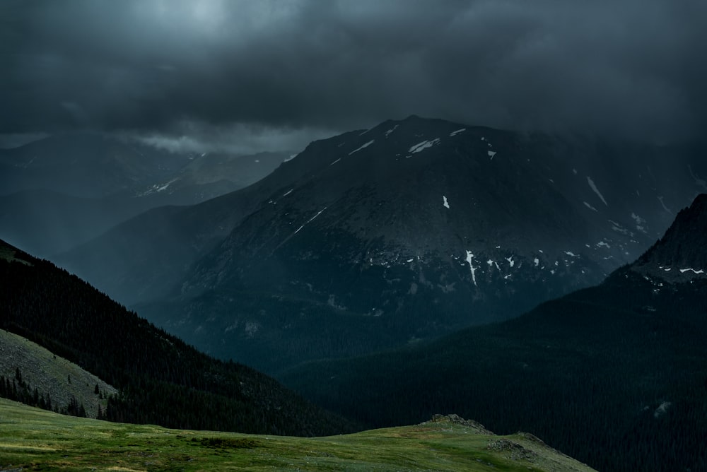 a view of a mountain range under a cloudy sky