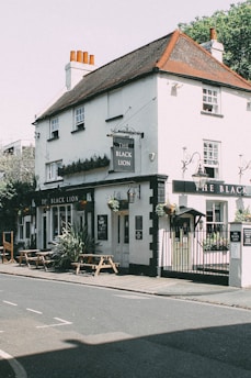 A picturesque view of the Golden Lion, a historic timber-frame building in Cannon Hill Park.