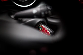 Technician programming a smart car key using specialized diagnostic equipment.