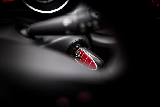 Close-up of a locksmith programming a car key with specialized tools.